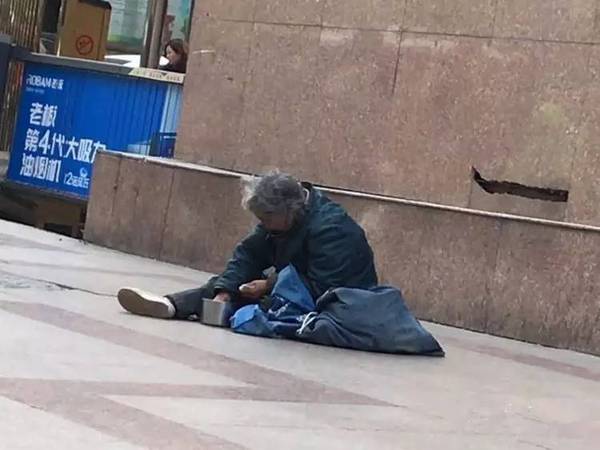 记者见到了微博中扔掉爱心市民赠与麻花的这名女乞丐,虽然下着小雨