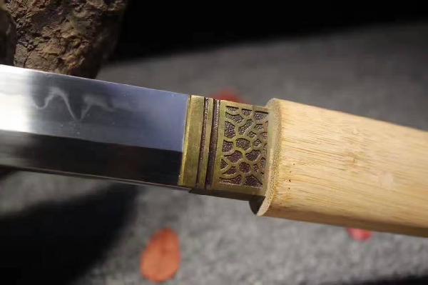 楠竹T10烧刃弯款唐刀--居合刑天 〖特点〗:此刃型为大V刃面平整锋利劈砍阻力小,整体刀型由刀簇向刀尖径向逐渐加宽,轴向渐薄锻打,采用覆土烧刃工艺加温至1200度,在冷水中淬火,温度骤降从而产生烧刃线,刃口具备超高硬度,刀背韧性仍保留,从而达到刚柔并济优质刀剑,正是一刀两世界,相生相克! 黄金比例重心护手前10厘米,二级黑檀木色泽柔亮手感细腻,一款收藏级刀剑! 〖总长〗:103厘米 〖刃长〗:72 厘米 〖柄长〗:27厘米 〖刃宽〗:3.