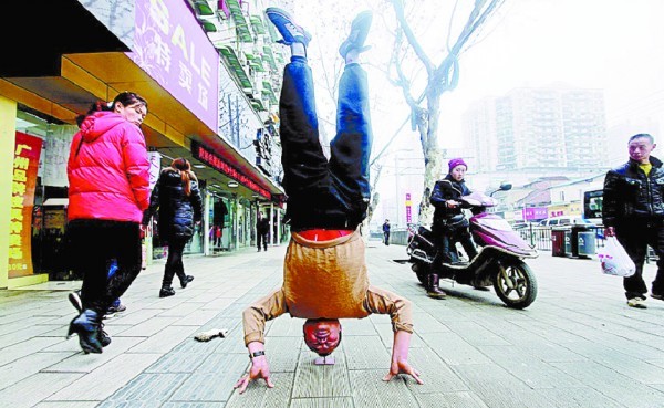 武汉男子"铁头功" 头顶铁钉倒立40秒(图)(1)_科技频道_光明网