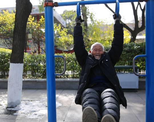 大爷在公园玩吊环