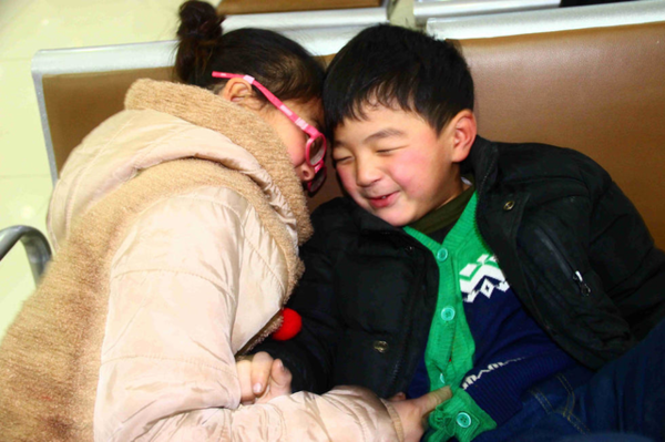 孩子们很内向.在等待检查的间隙,姐弟玩闹在一起,很开心.